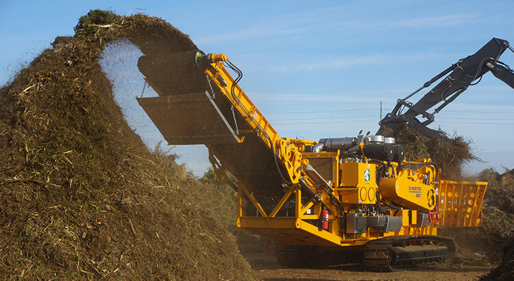 Horizontal grinder processing compost
