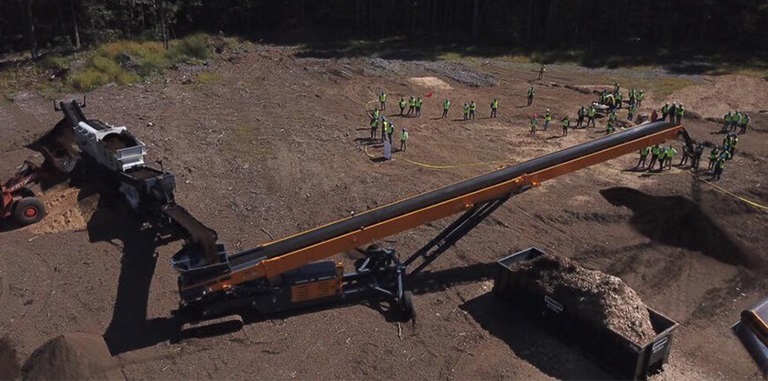 CBI's TC75R Tracked Radial Stacker Conveyor Working Onsite In Newton, New Hampshire At CBI's Factory Forum.