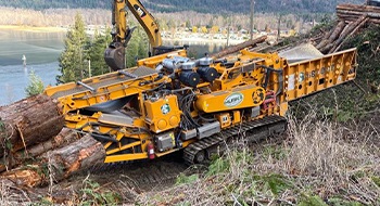 Horizontal wood grinder in a land clearing project