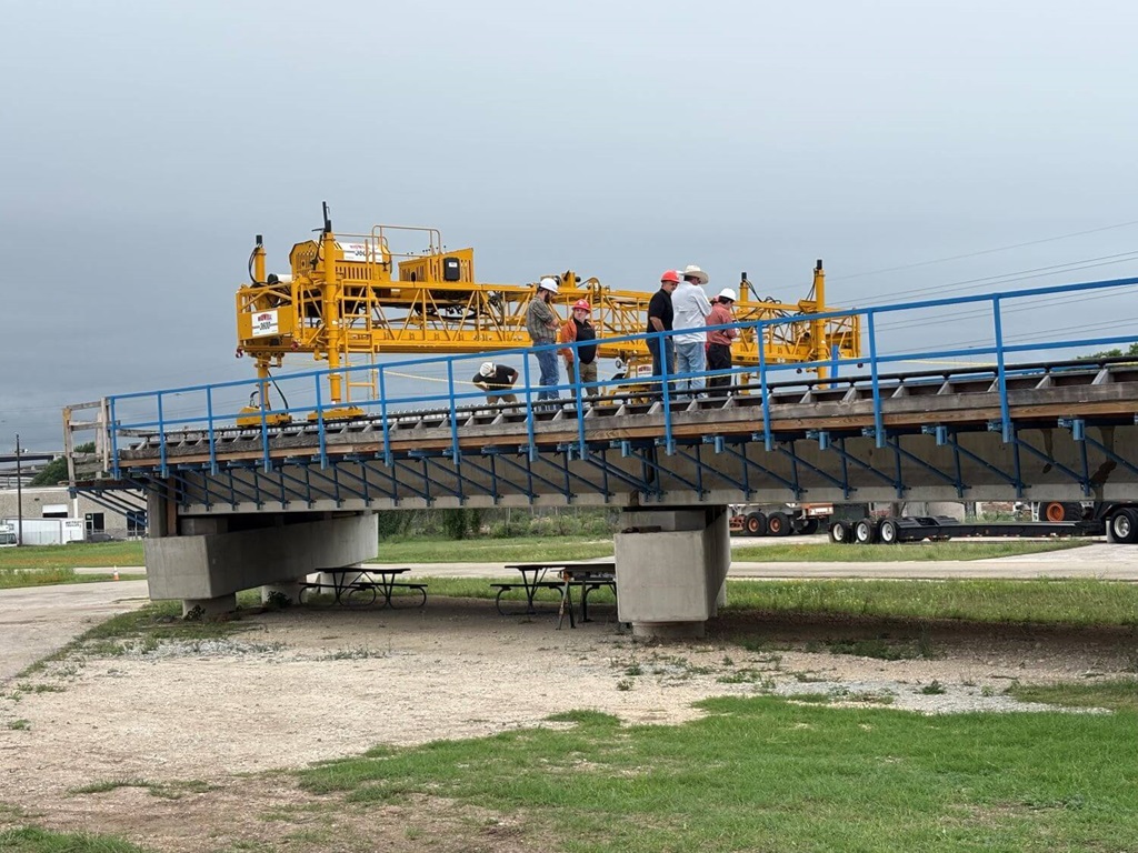 Construction Workers On Bridge Using a Bid-Well Paver