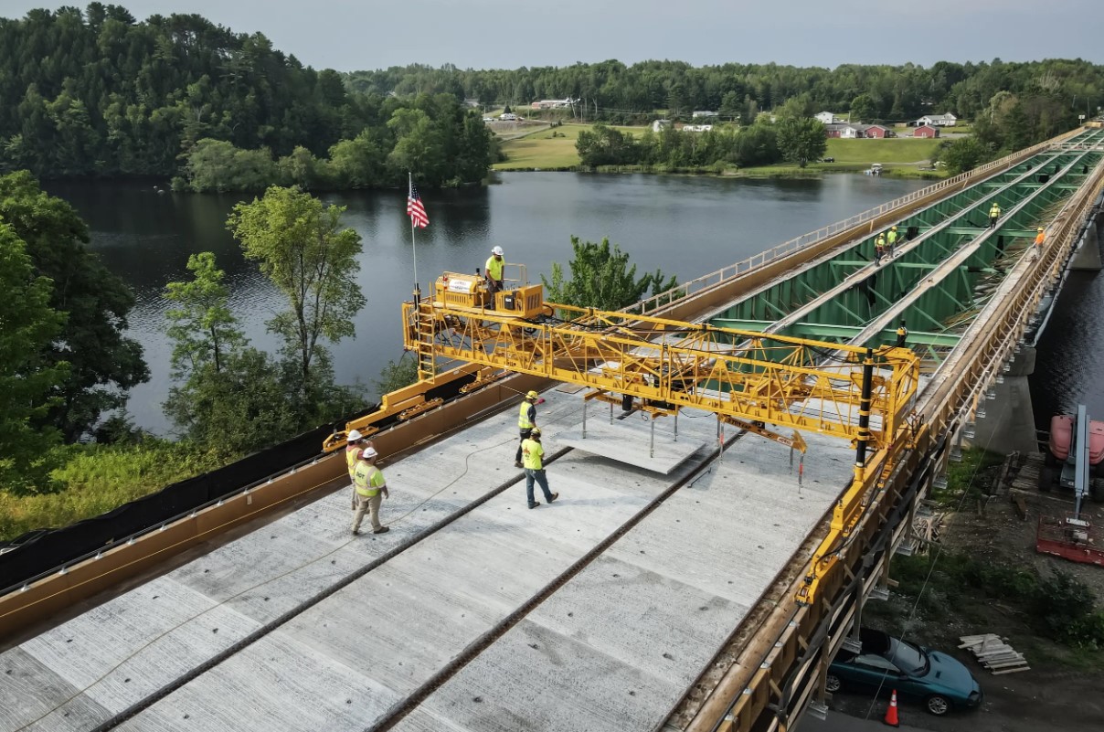 Bid-Well Material Mover Placing Concrete Slab On A Bridge