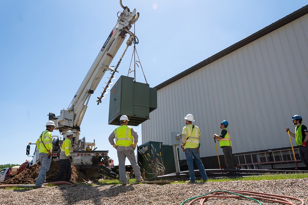 Terex Digger Derrick Lifting a Transformer