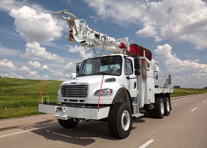 Terex Commander Digger Derrick driving down highway