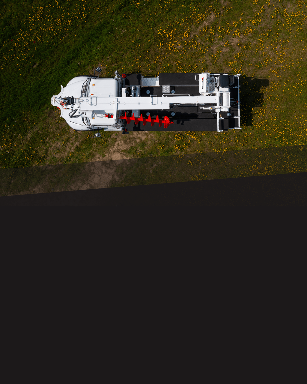 Overhead shot of Terex digger derrick parked in field