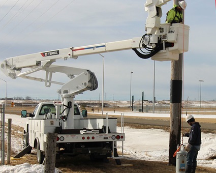 Utility worker lifting a transformer with a Terex bucket truck