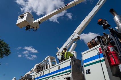 Utility lineworker operating Terex bucket truck