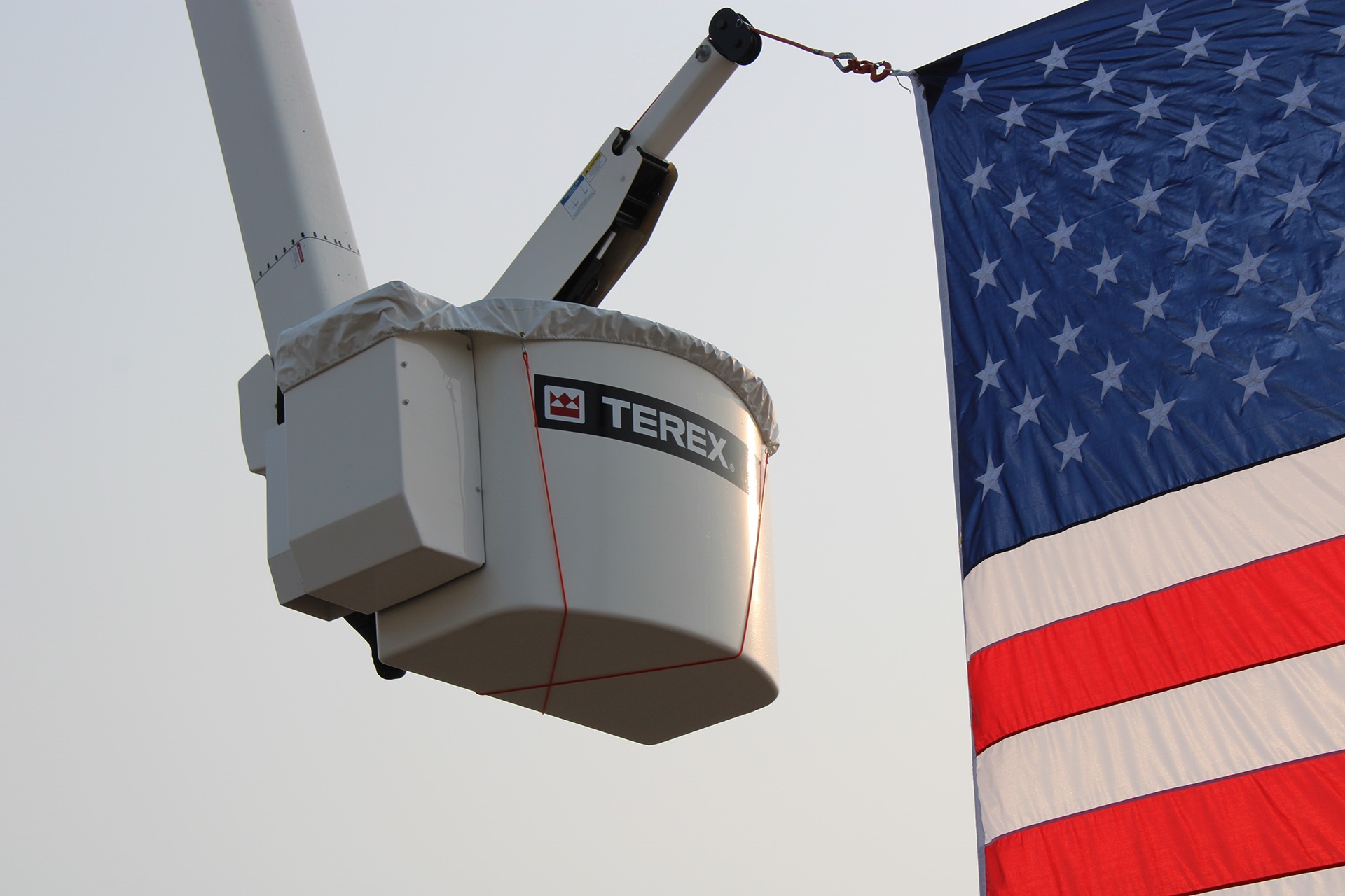 Terex bucket truck holding American flag