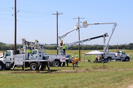 Terex Hands On participants operating Terex bucket trucks and Terex digger derricks