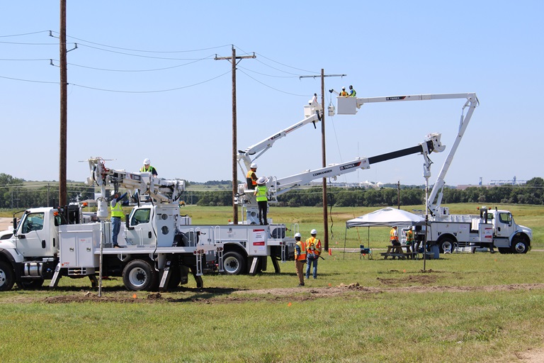 Terex Hands On participants operating Terex bucket trucks and Terex digger derricks