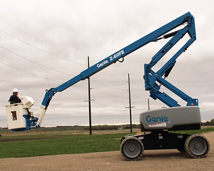 Genie Z-60 Lift in a gravel lot