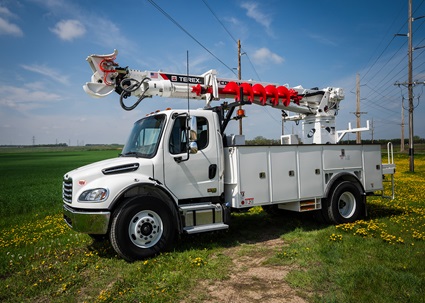 Terex digger derrick sitting in field