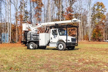 Terex XTPro6070 tree trimmer bucket truck parked in forest
